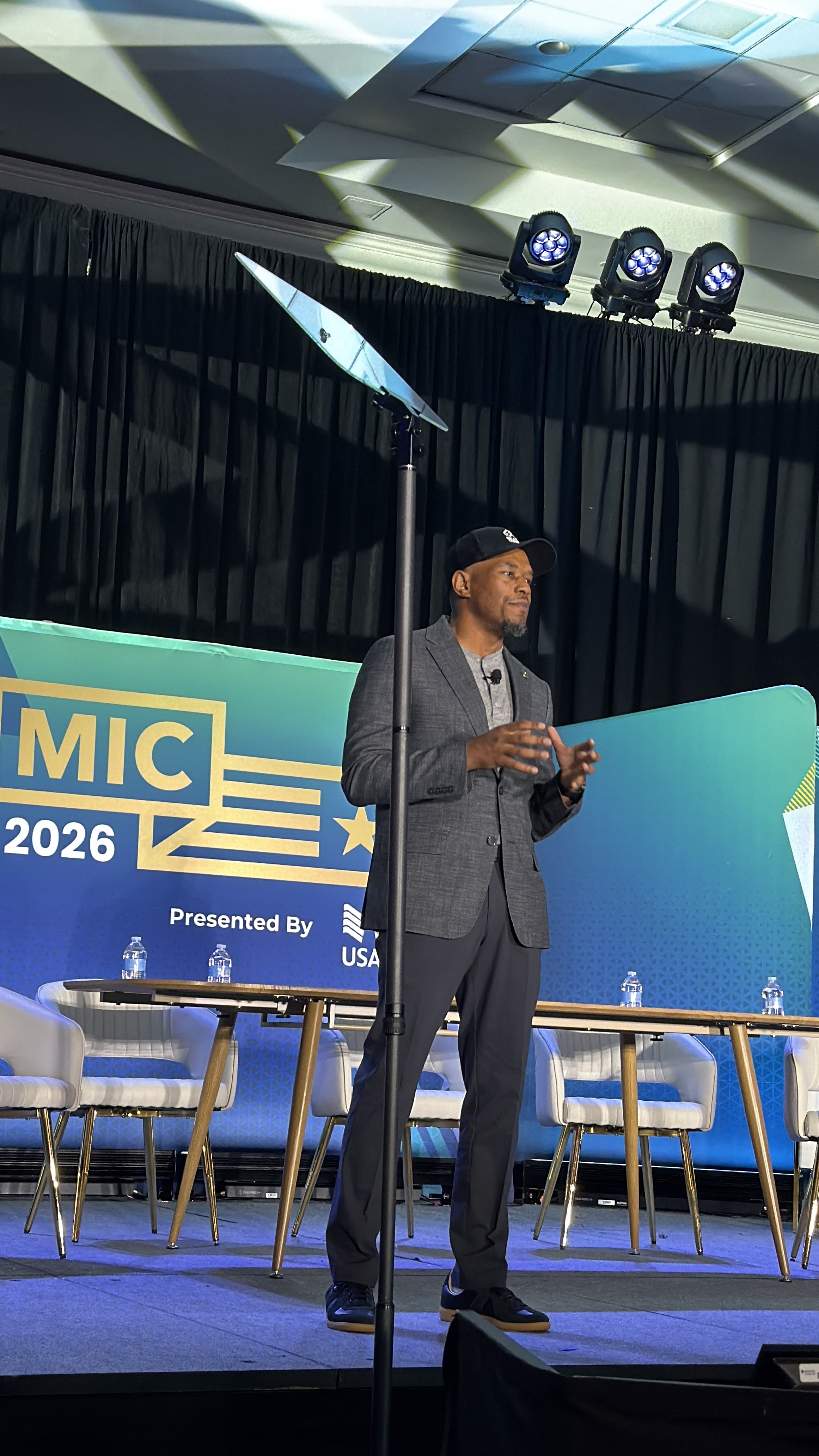 Curtez Riggs speaking on stage at the Military Influencer Conference 2026